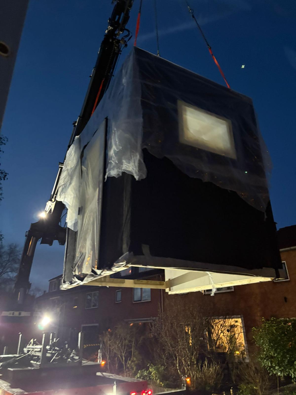 Prefab aanbouw in de kraan